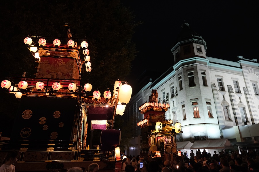 October festival floats at night.