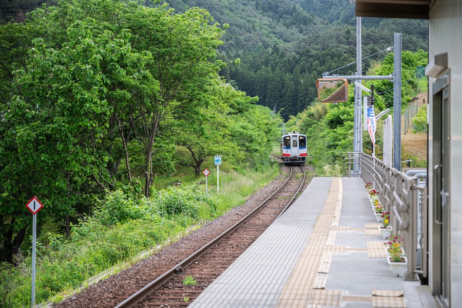 Local train arriving at rural station Japan.