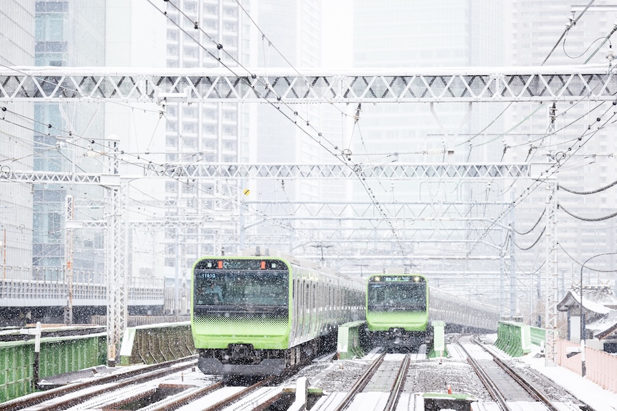 Japanese trains running in snowy weather.