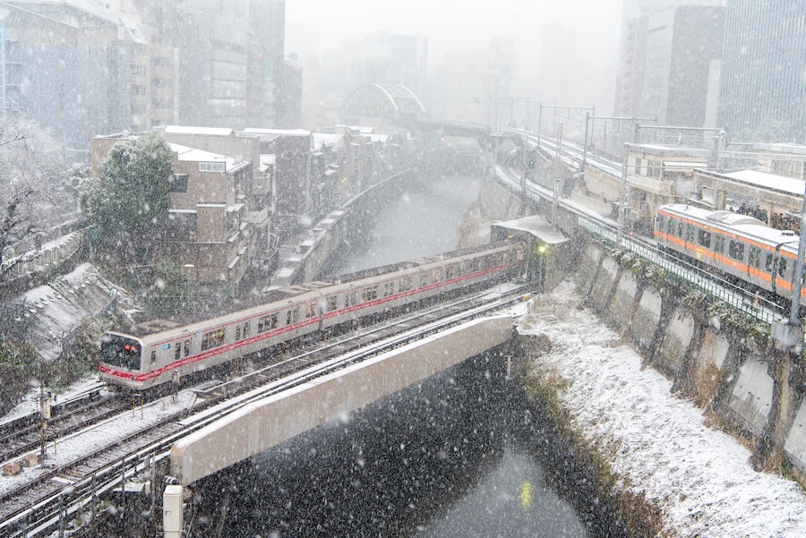 Trains continue to run in Tokyo during snowfall.